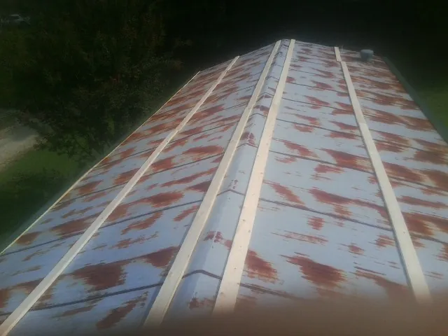 Rusted metal roof panels with new wood purlins before replacement — Storm Damage Roof Repair in Mad River by Roofing Brothers